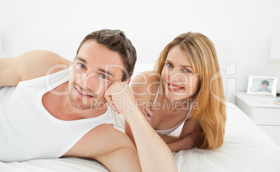 Couple lying down together in their bed