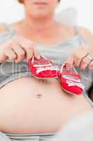 Pregnant woman with kids shoes