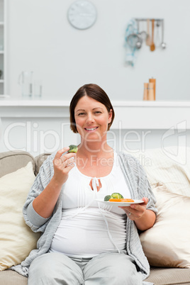 Pregnant woman eating vegetables