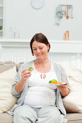 Pregnant woman eating vegetables