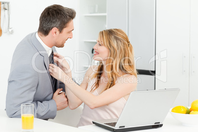 Woman adjusting the tie of her husband