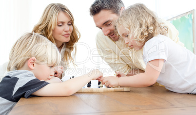Family playing chess on a table