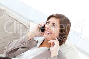 Smilng Businesswoman phoning on her sofa