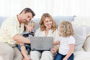 Family looking at their laptop