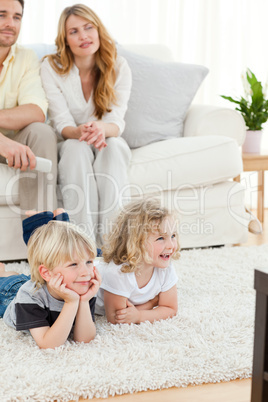 Adorable family watching tv