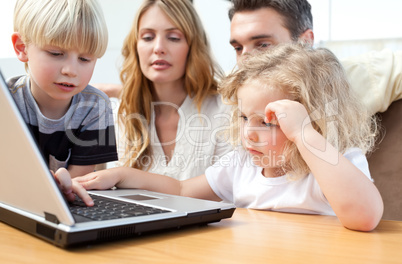 Family looking at their laptop