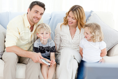 Adorable family watching tv