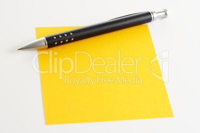 Gelber Notizzettel mit Kugelschreiber
