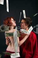 young man and woman under money fall