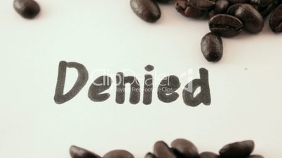 denied.  written on white under coffee
