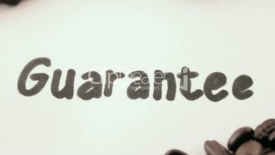 guarantee.  written on white under coffee