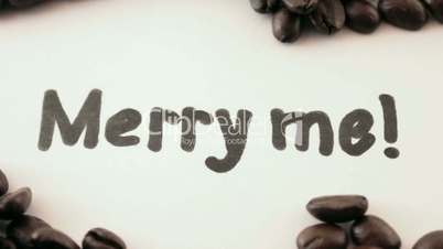 merry me.  written on white under coffee