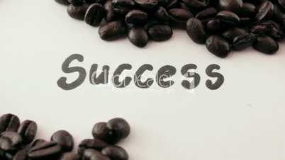success.  written on white under coffee