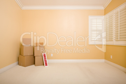 Moving Boxes and Foreclosure Real Estate Sign on Floor in Empty
