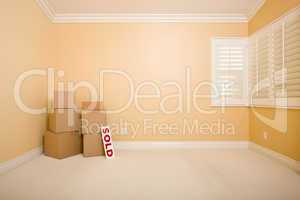 Moving Boxes and Sold Real Estate Sign on Floor