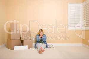 Upset Woman on Floor Next to Boxes and Blank Sign
