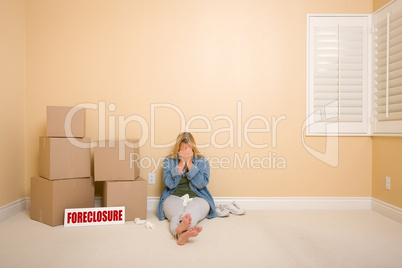 Upset Woman on Floor Next to Boxes and Foreclosure Sign