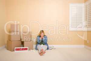 Upset Woman on Floor Next to Boxes and Foreclosure Sign