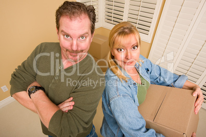 Goofy Couple and Moving Boxes in Empty Room