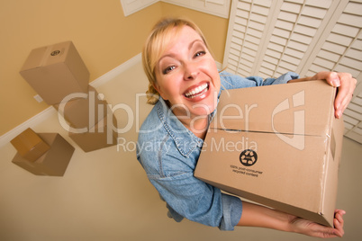Excited Woman Holding Moving Boxes in Empty Room