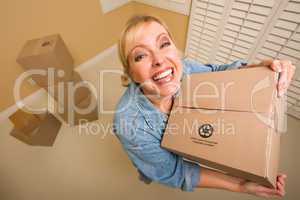 Excited Woman Holding Moving Boxes in Empty Room