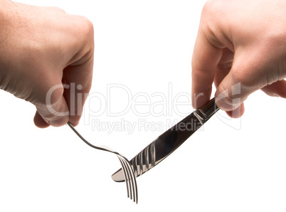 hands holding empty fork and knife