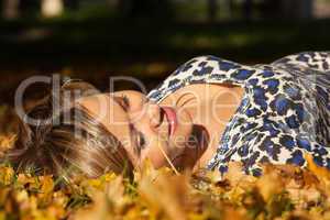 woman lay on ground in leaves