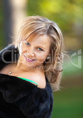 Beauty woman in fur coat look at you