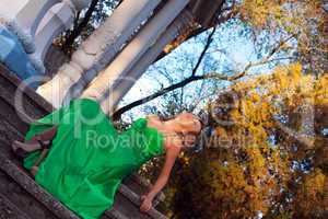 Beauty woman in green clothes sit on stair