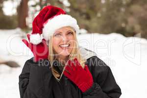 Attractive Santa Hat Wearing Blond Woman Having Fun in Snow