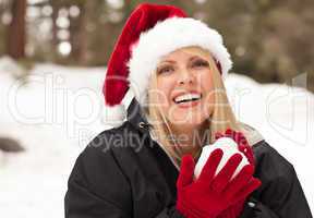 Attractive Santa Hat Wearing Blond Woman Having Fun in Snow