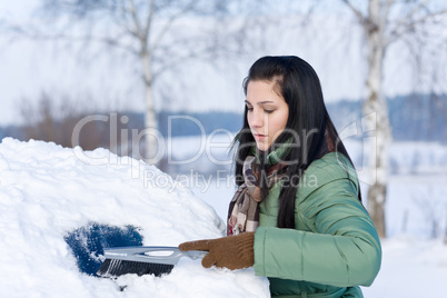 Winter car - woman remove snow from windshield