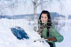 Winter car - woman remove snow from windshield