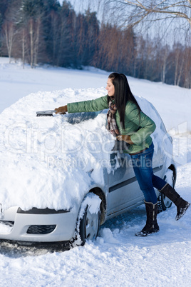 Winter car - woman remove snow from windshield