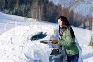 Winter car - woman remove snow from windshield
