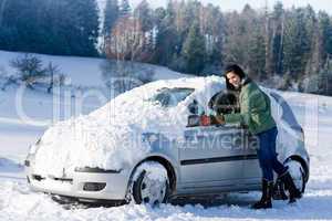 Winter car - woman remove snow from windshield