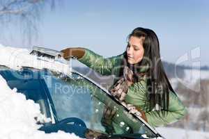 Winter car - woman remove snow from windshield