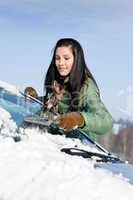 Winter car - woman remove snow from windshield