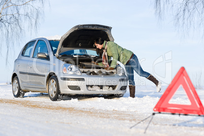 Winter car breakdown - woman repair motor