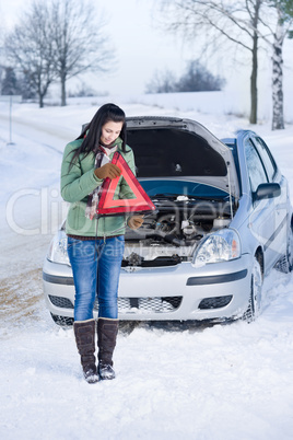 Winter car breakdown - woman warning triangle