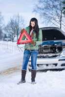 Winter car breakdown - woman warning triangle