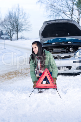 Winter car breakdown - woman warning triangle