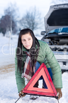 Winter car breakdown - woman warning triangle