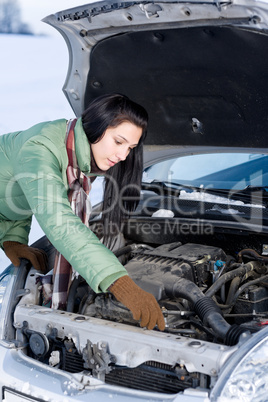 Winter car breakdown - woman repair motor