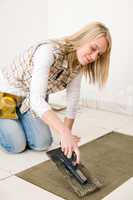 Home improvement, renovation - handywoman laying tile