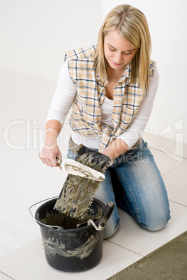 Home improvement, renovation - handywoman laying tile