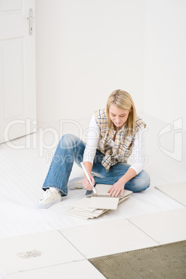 Home improvement - handywoman measuring tile