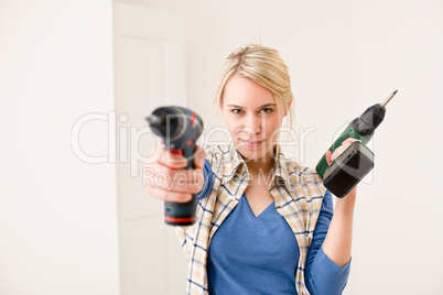Home improvement - woman with battery screwdriver