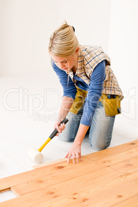 Home improvement - handywoman installing wooden floor