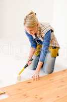 Home improvement - handywoman installing wooden floor